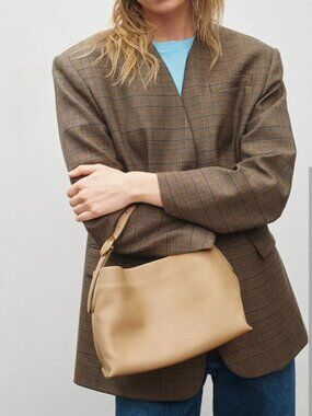 The Vince Plonge Vivian Small Hobo Bag epitomizes understated luxury with its bu